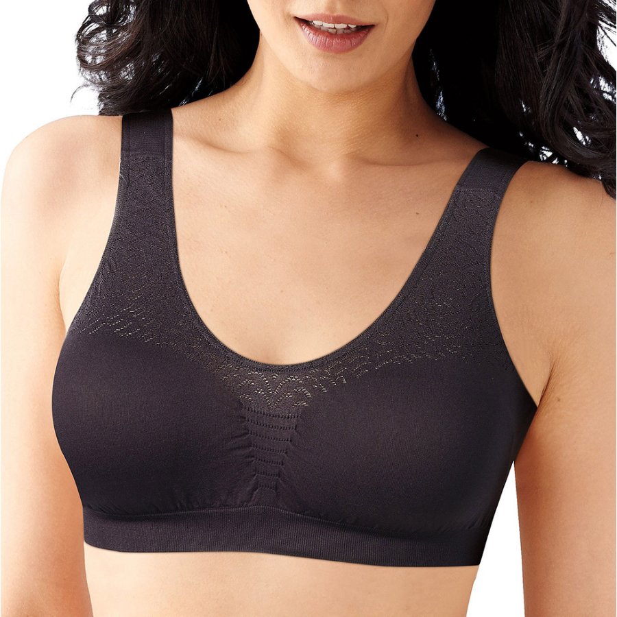 Woman wearing a black bralette on a white background