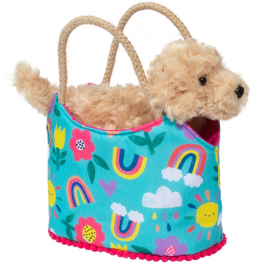 Toy dog in a colorful bag with rainbow and cloud patterns on a white background