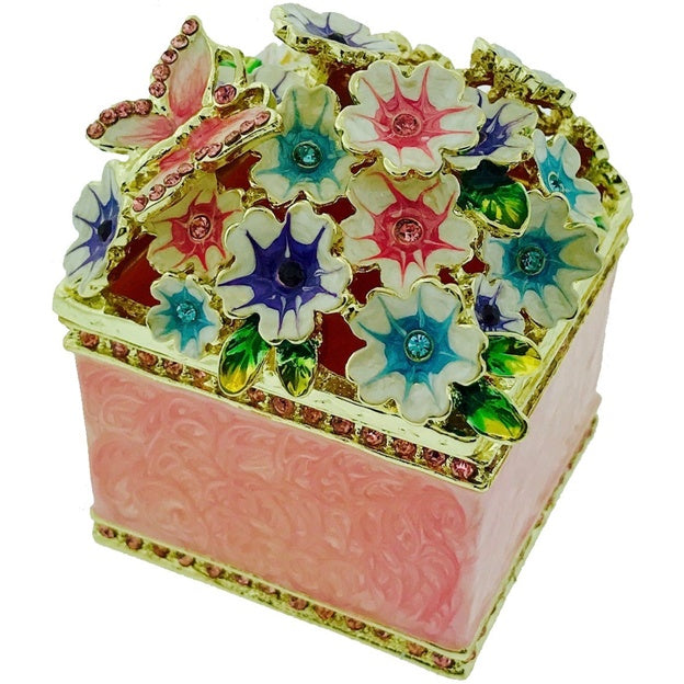 Decorative jewelry box with floral designs and colorful gemstones on a white background