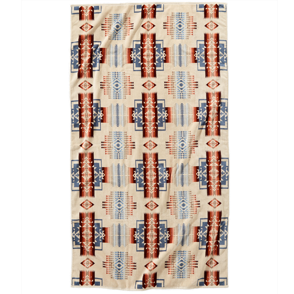 Beige towel with red and blue geometric pattern on a white background