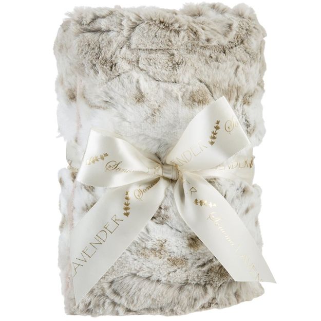 Fluffy blanket with a decorative bow on a white background