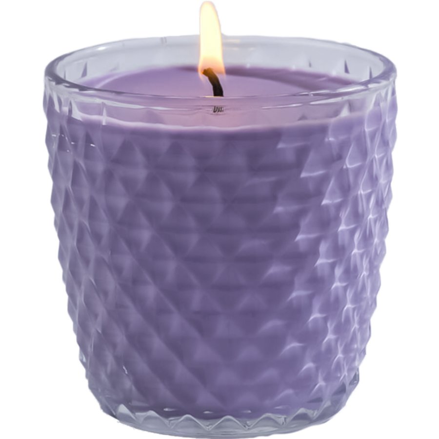 Purple candle in a textured glass holder on a white background