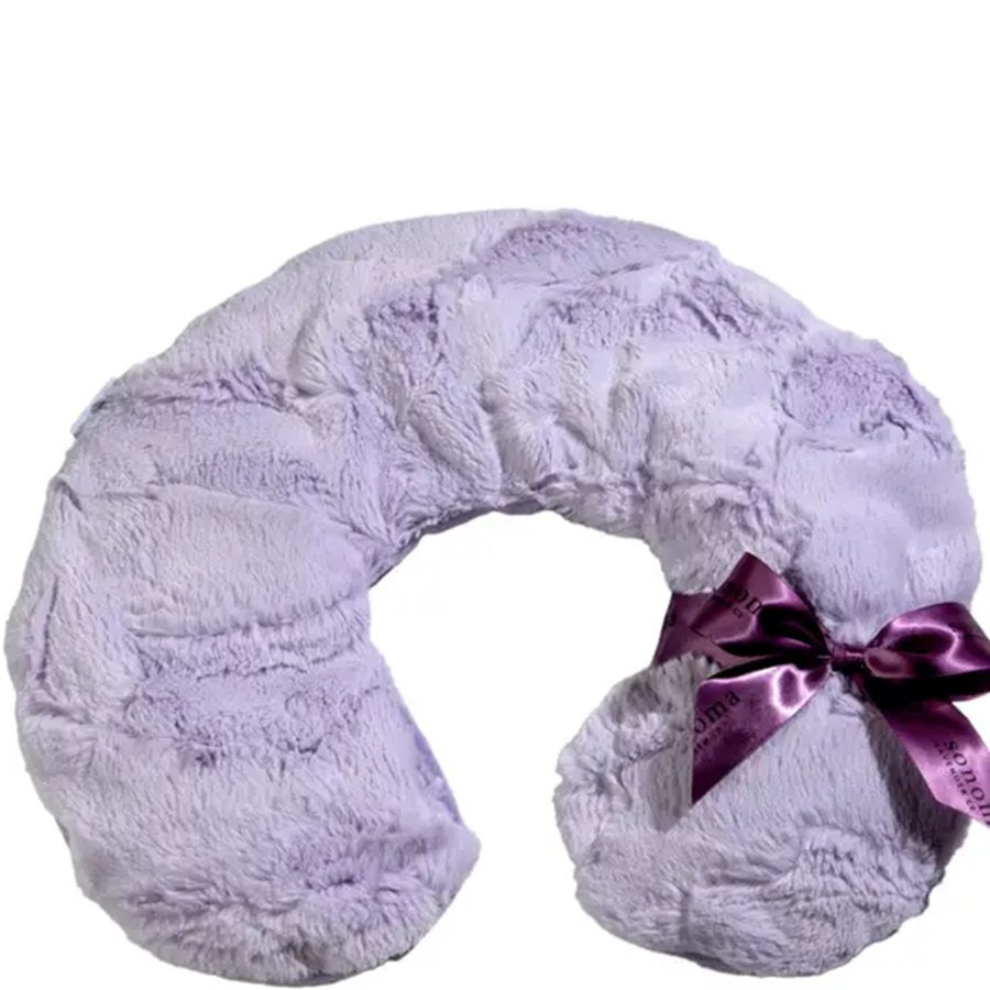 Fluffy lavender neck pillow with a purple ribbon on a white background