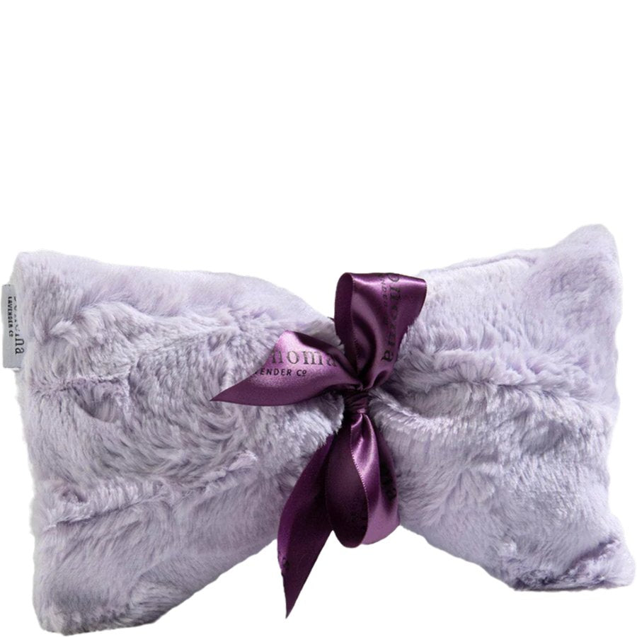 Fluffy pillow with a purple satin bow on a white background