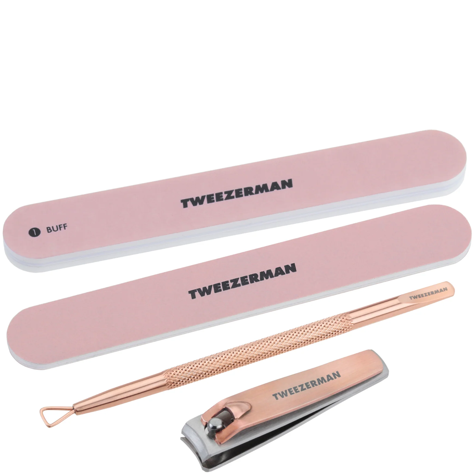 Tweezerman nail care set with pink and rose gold tools on a white background