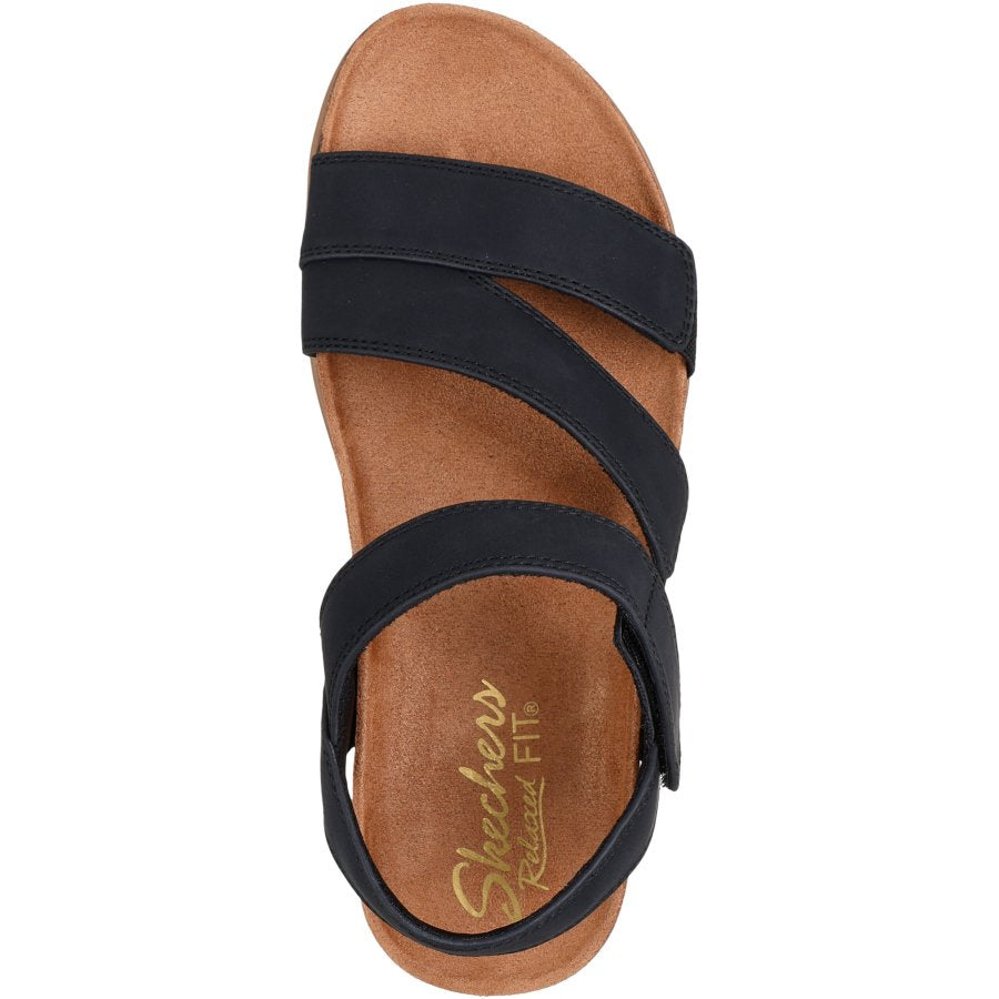 Black sandal with brown sole on a white background