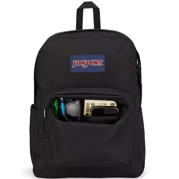 Black JanSport backpack with front pocket contents on a white background