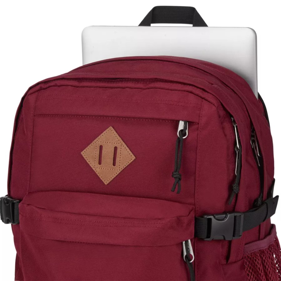 Red Jansport backpack with a brown diamond logo on a white background
