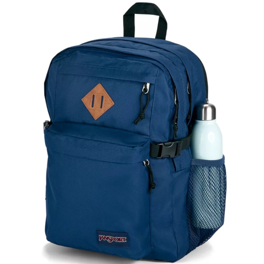 Blue Jansport backpack with a brown patch and water bottle holder on a white background
