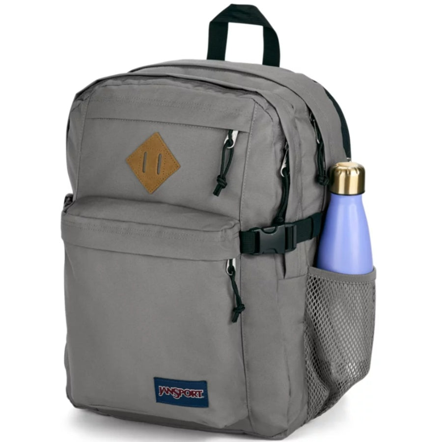 Gray Jansport backpack with a water bottle in a pocket on a white background