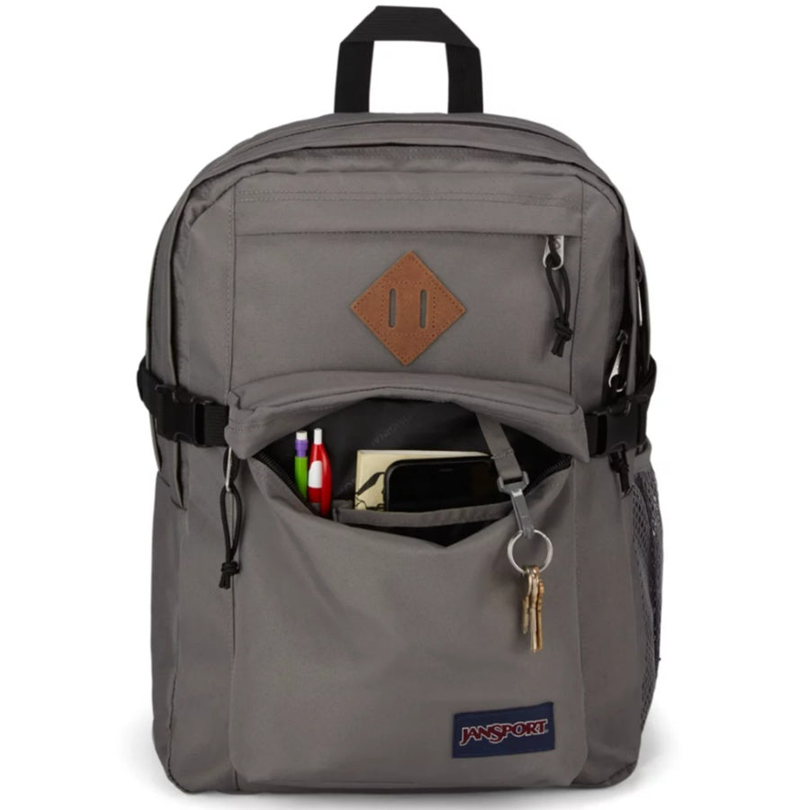 Gray backpack with a brown leather patch and visible Jansport logo on a white background