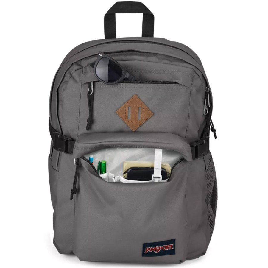 Gray backpack with a brown leather patch and visible JanSport logo on a white background