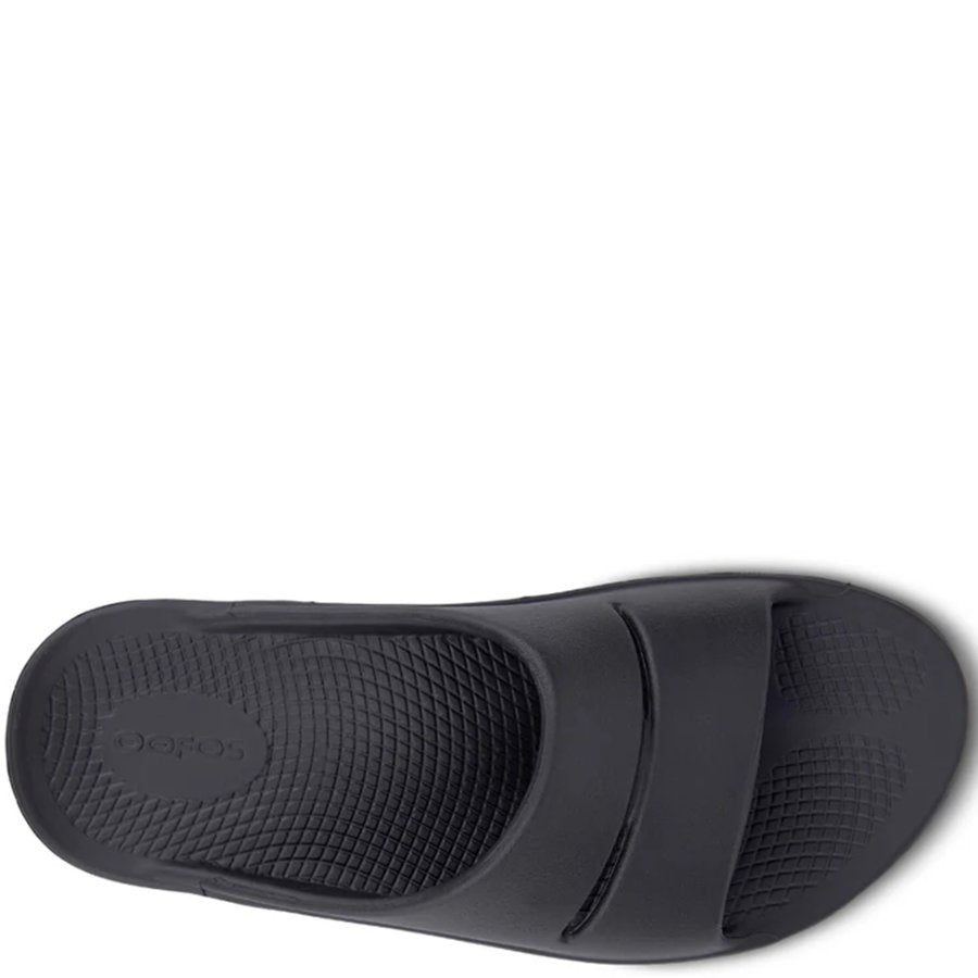 Black slide sandal on a white background