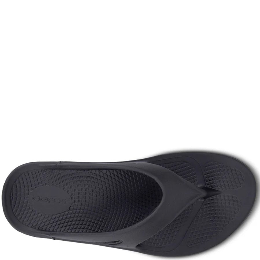 Black sandal with a textured sole on a white background