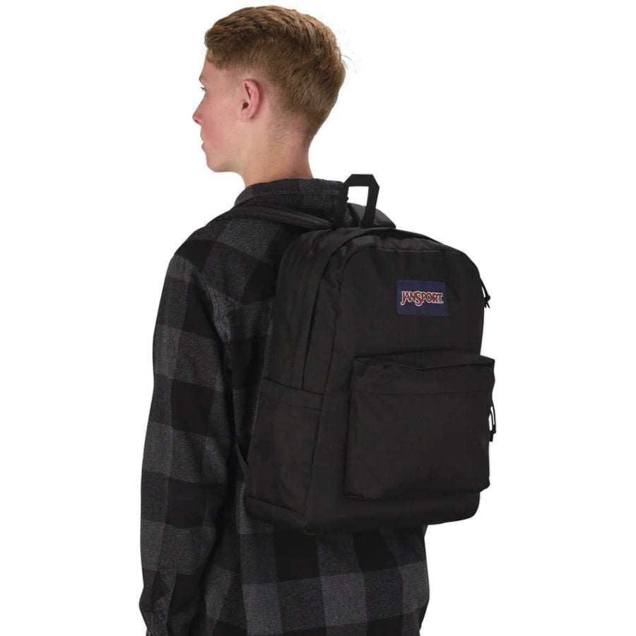 Person wearing a black Jansport backpack with a visible brand logo on a white background