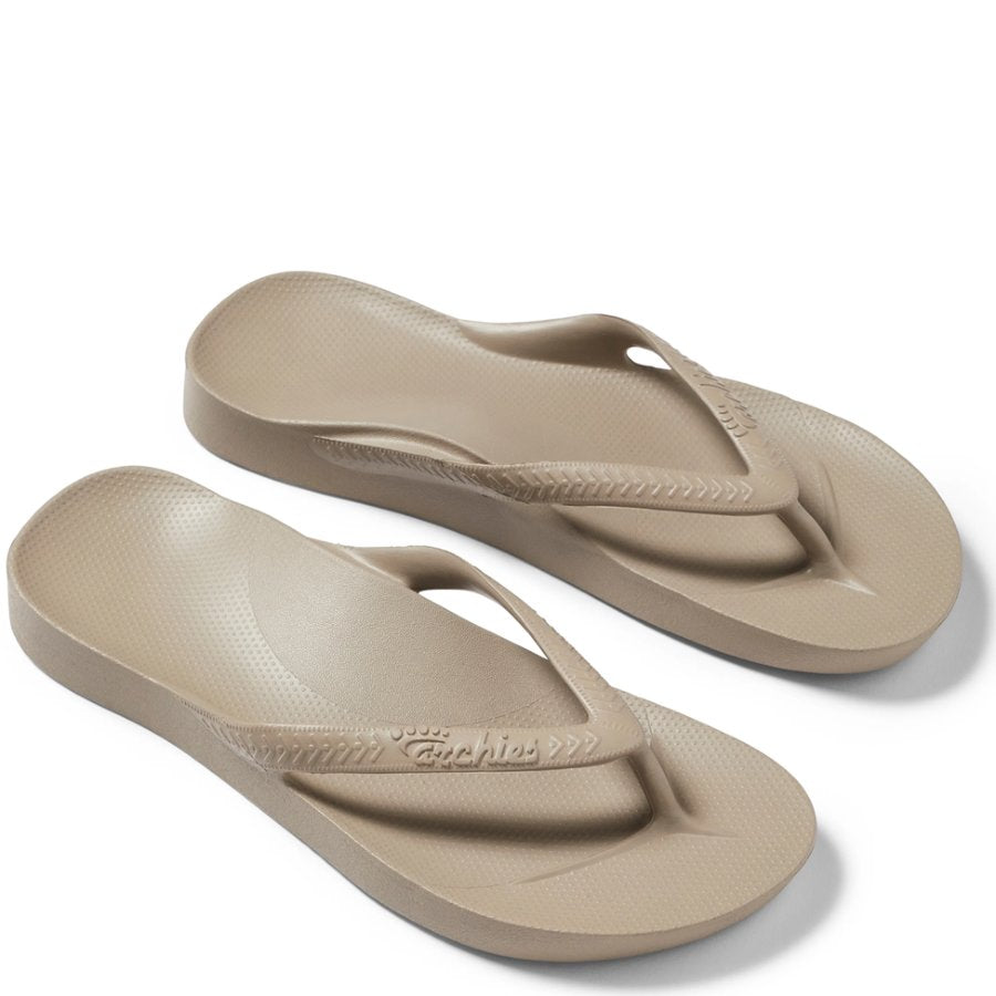 Pair of beige flip-flops on a white background