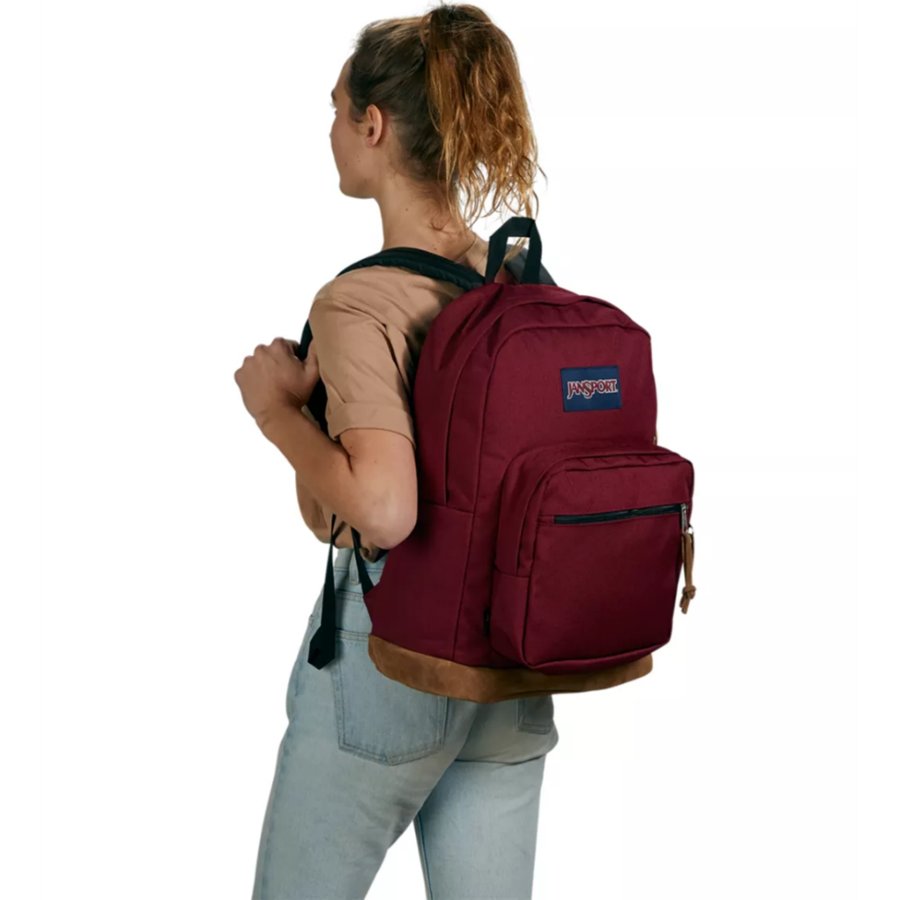 Person wearing a maroon Jansport backpack with a visible brand logo on a white background