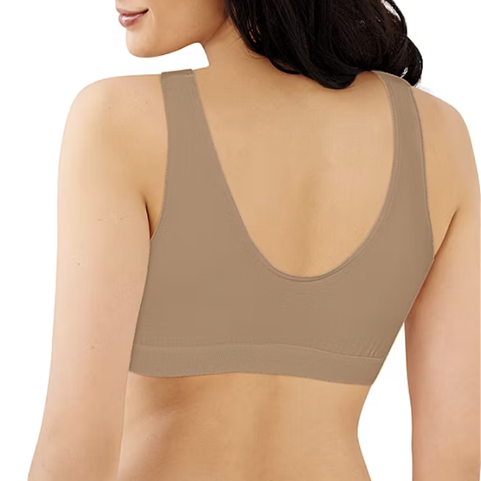 Beige sports bra worn by a model on a white background