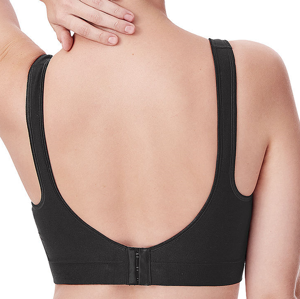 Black sports bra worn by a person on a white background