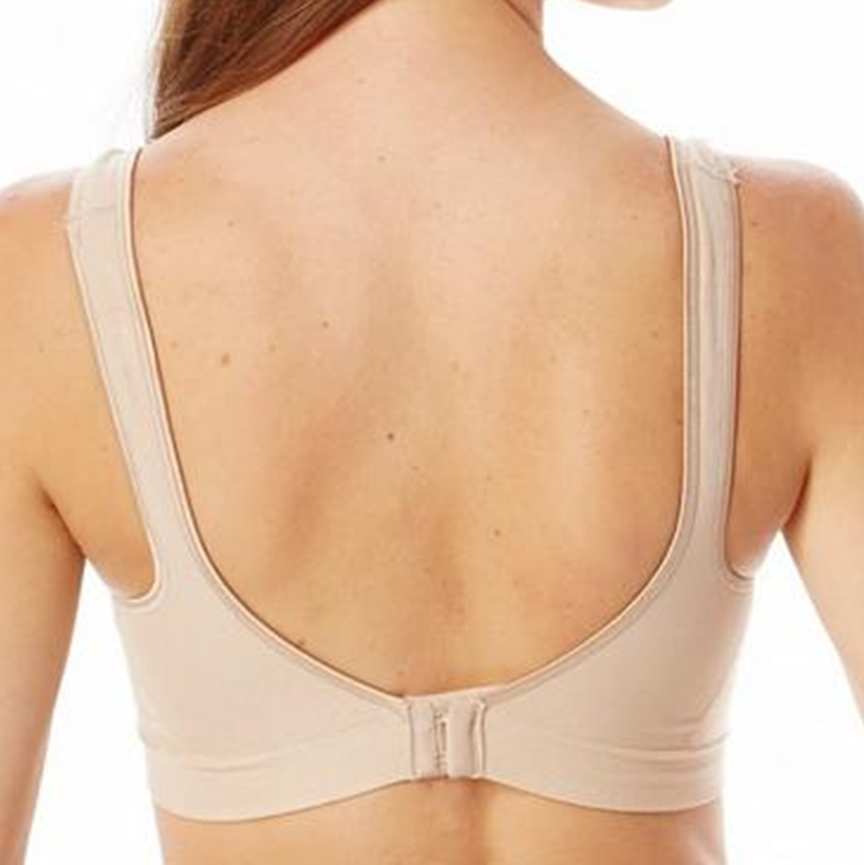 Beige bra worn by a person on a white background