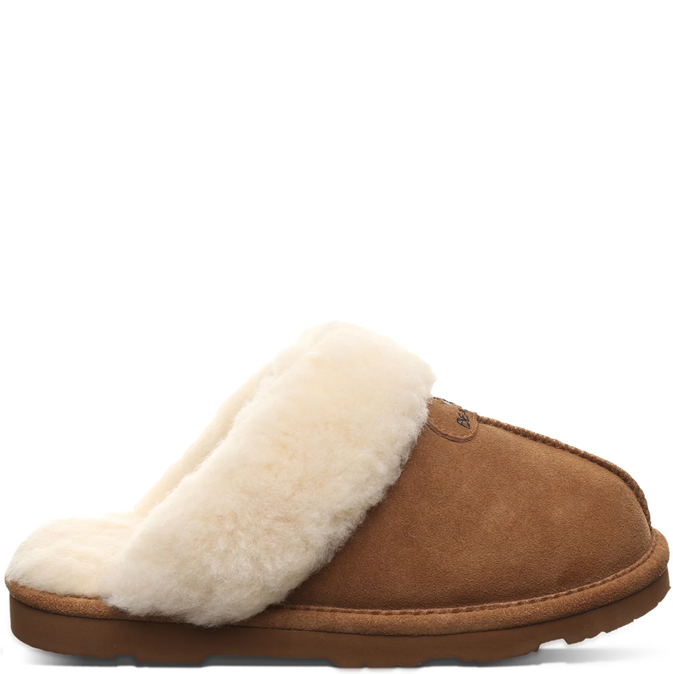 Brown slipper with white fur lining on a white background
