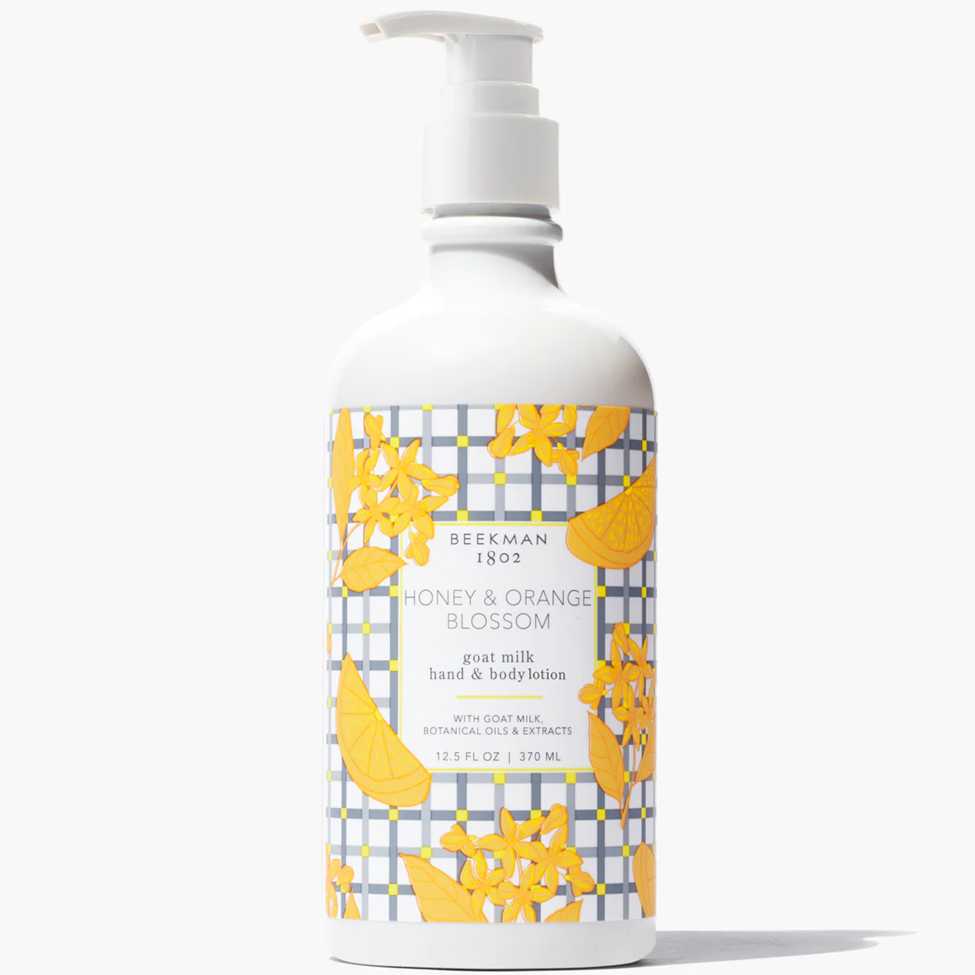 Bottle of Beekman 1802 Honey & Orange Blossom goat milk hand and body lotion on a white background