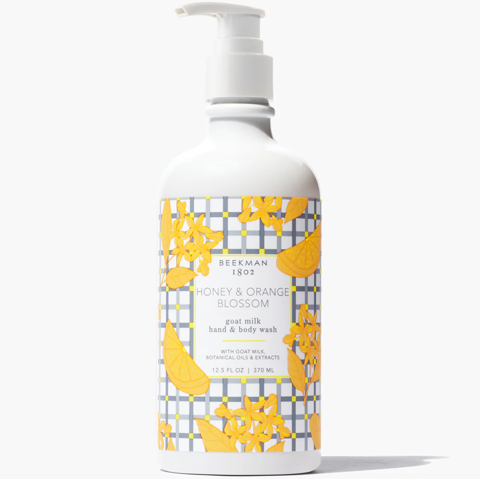 Hand and body wash bottle with floral design on a white background