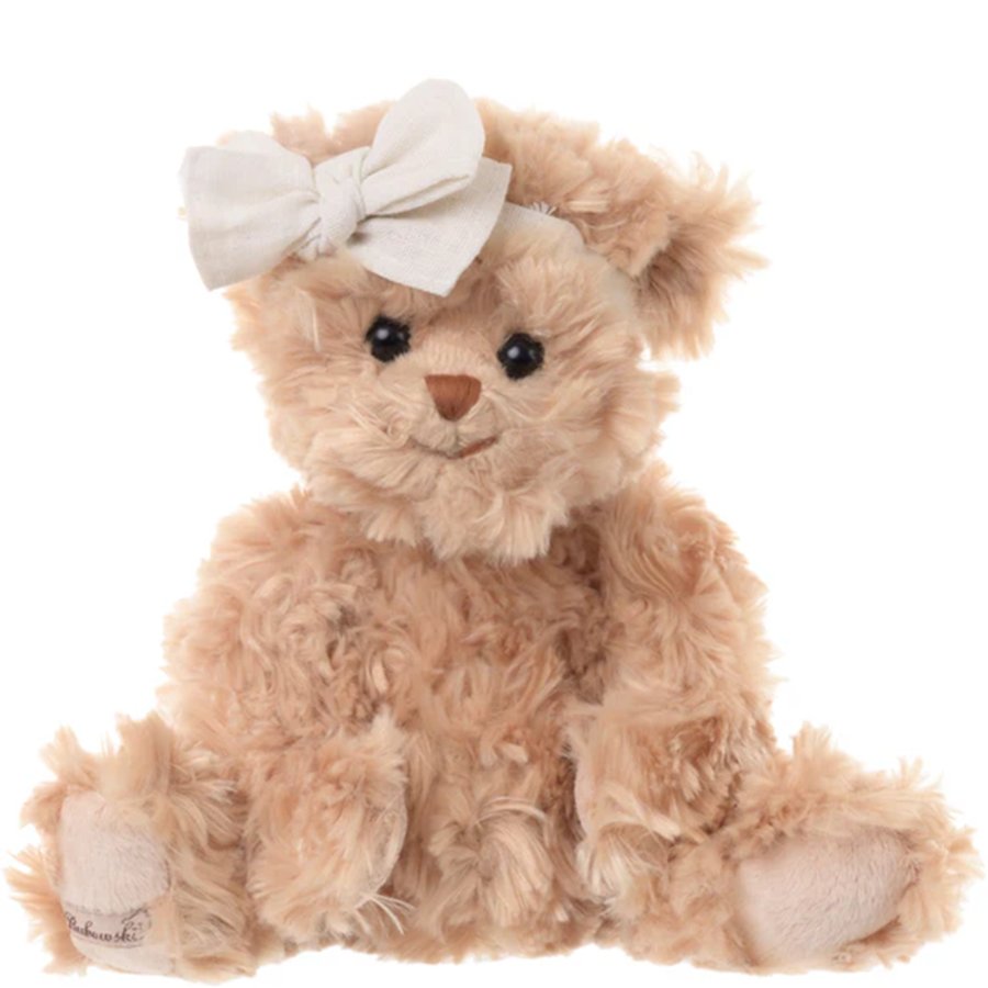 Plush teddy bear with a white bow on a white background