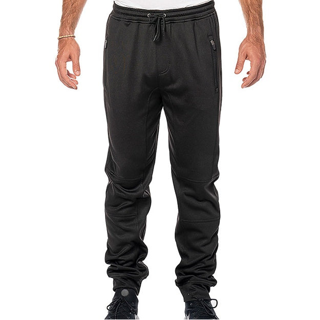 Black jogger pants worn by a person on a white background