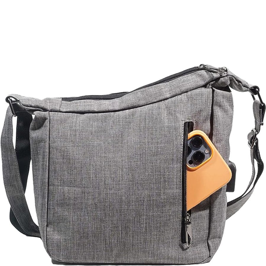 Gray shoulder bag with a pocket holding a smartphone on a white background