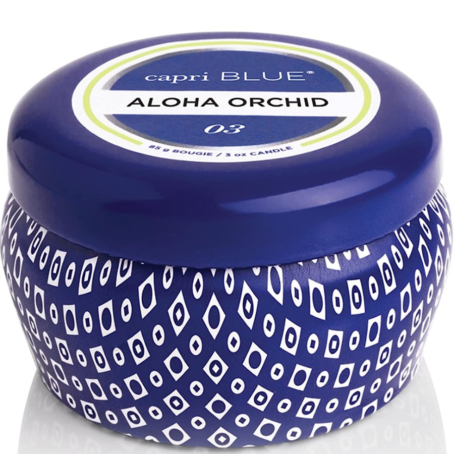 Capri Blue Aloha Orchid candle with blue lid and patterned container on a white background