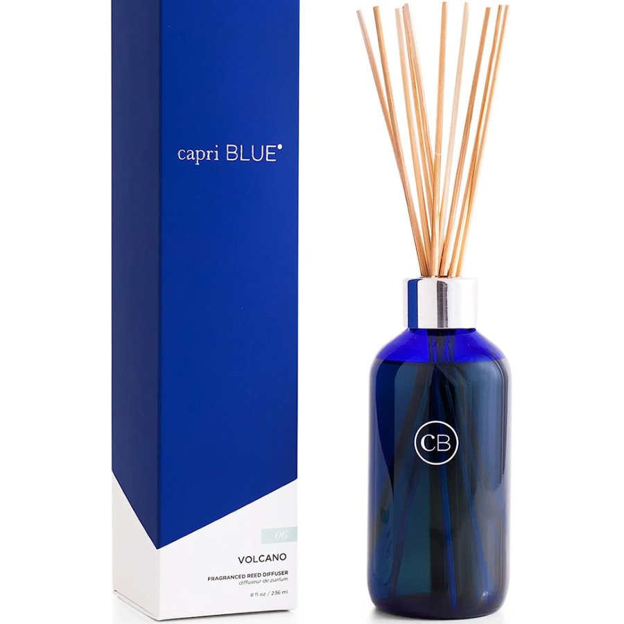 Blue diffuser bottle with wooden sticks and packaging on a white background