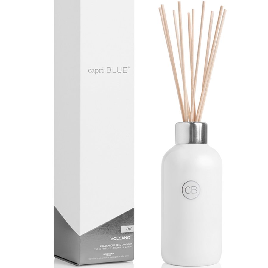 White diffuser bottle with wooden sticks and 'capri BLUE' packaging on a white background