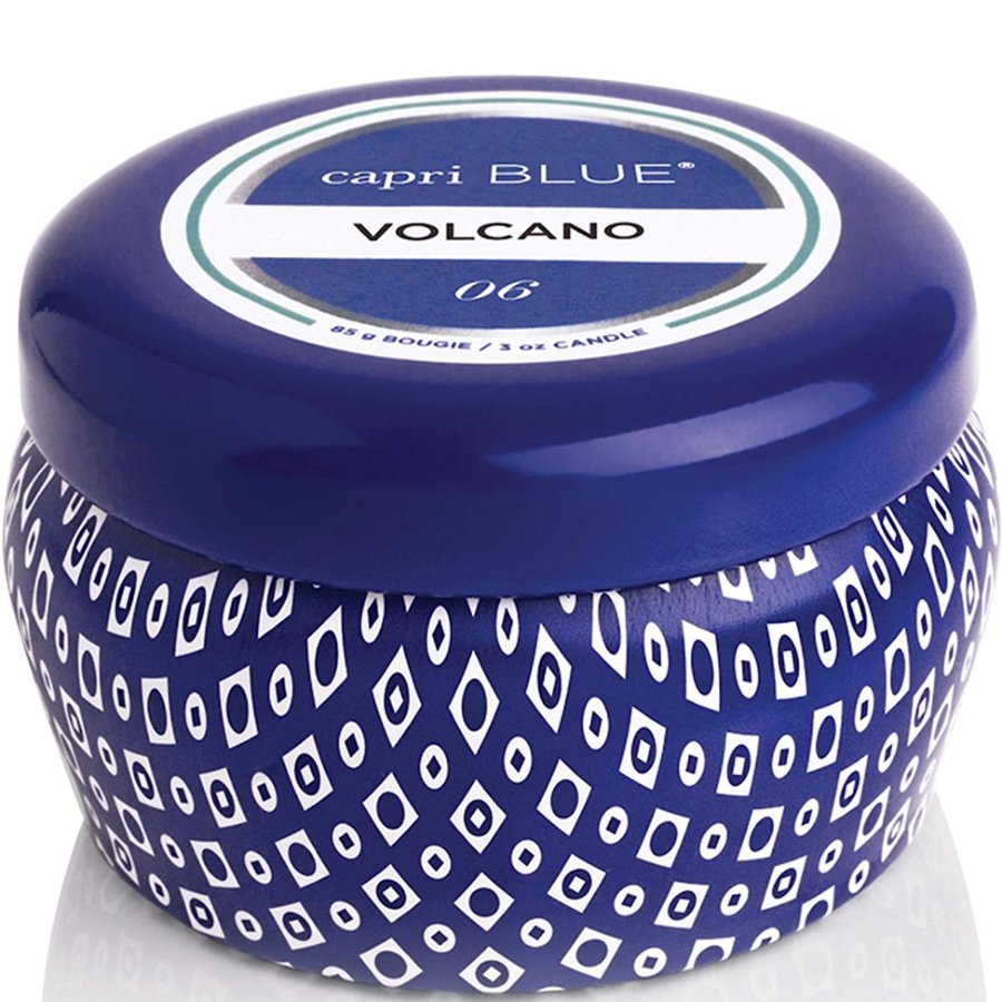 Capri Blue Volcano candle with blue lid and patterned container on a white background