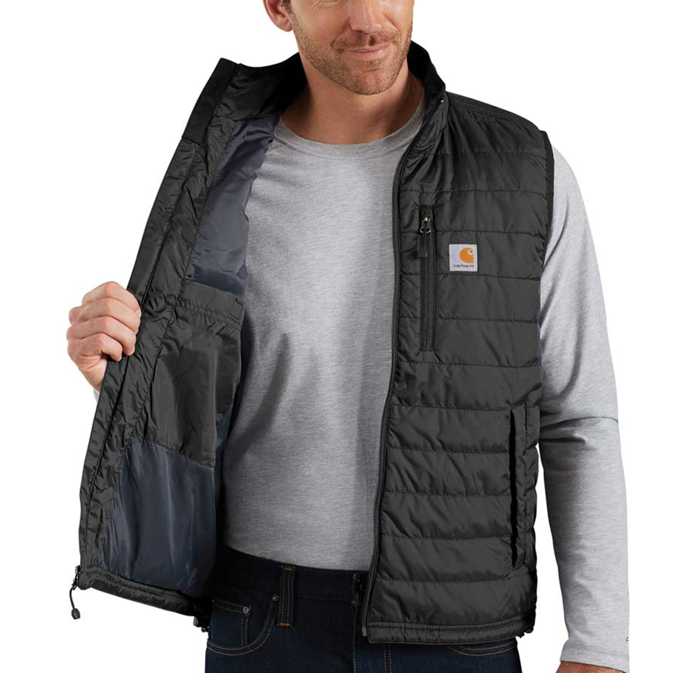 Man wearing a black Carhartt vest over a gray shirt on a white background