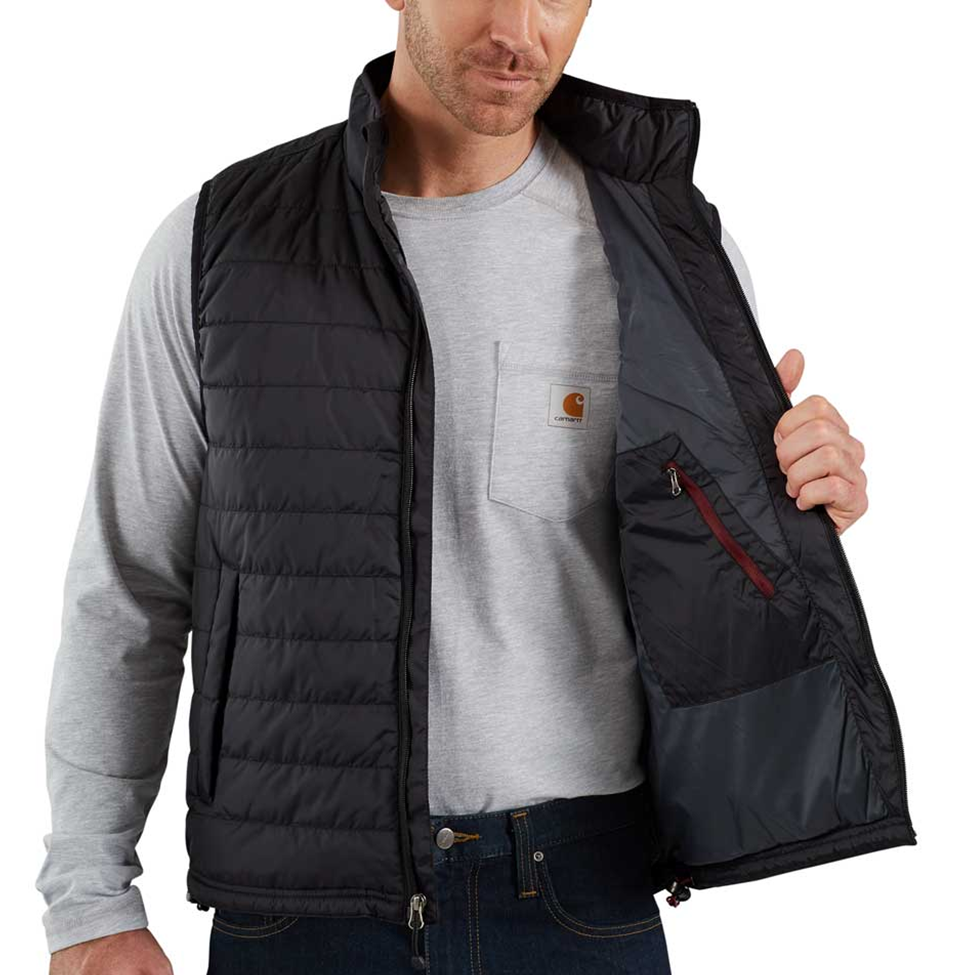 Man wearing a black puffer vest over a gray shirt on a white background