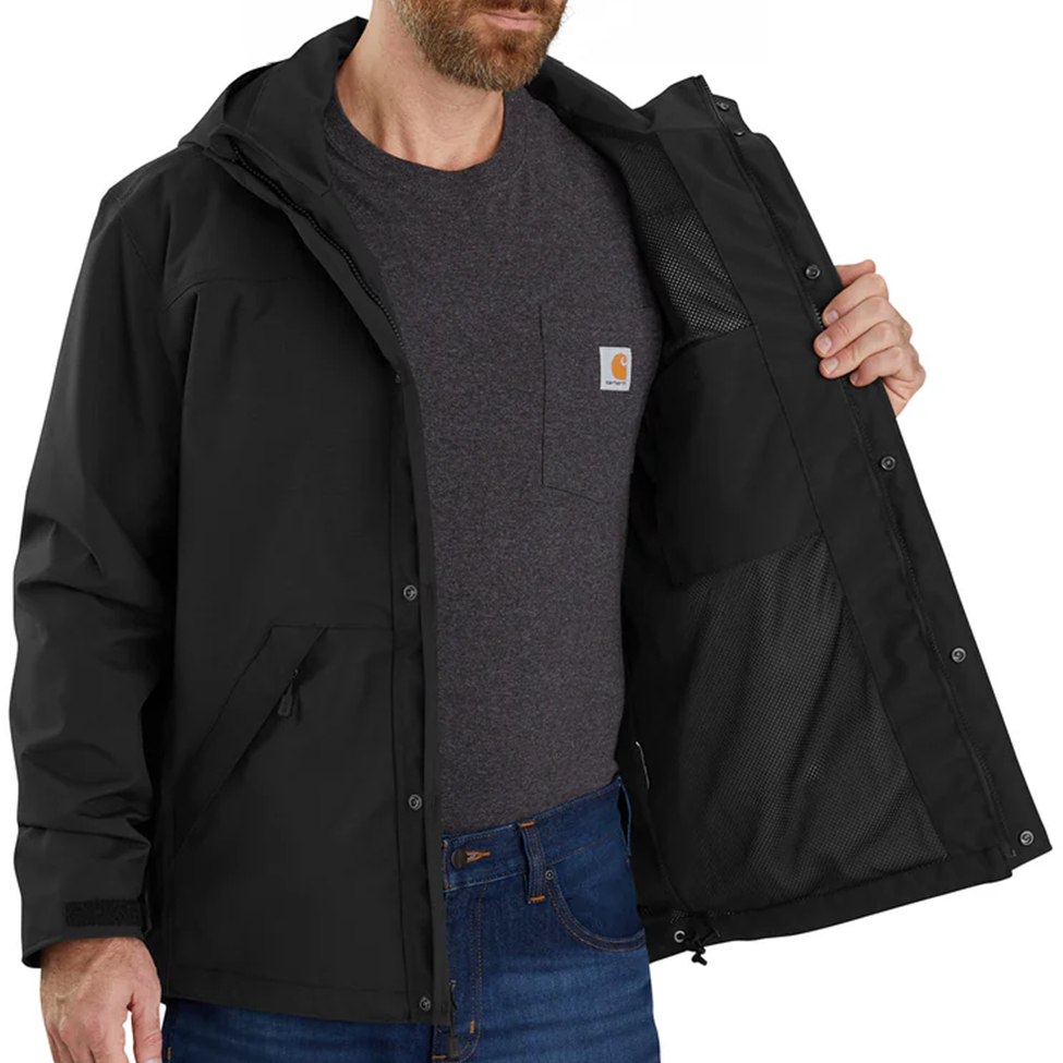 Man wearing a black jacket with a visible brand logo on a white background