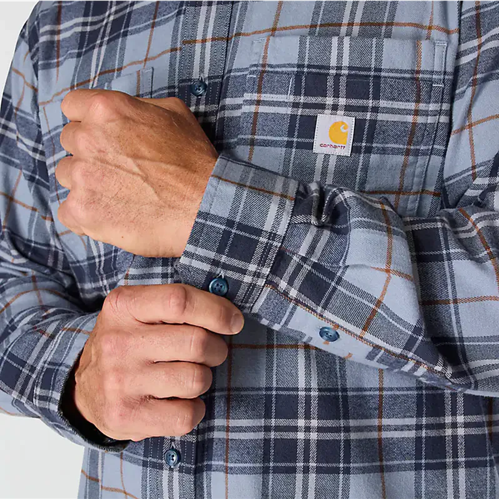 Close-up of a person wearing a plaid shirt with a visible brand logo on a white background