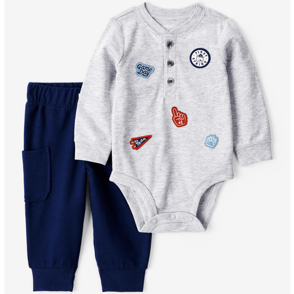 Gray onesie with colorful patches and navy pants on a white background