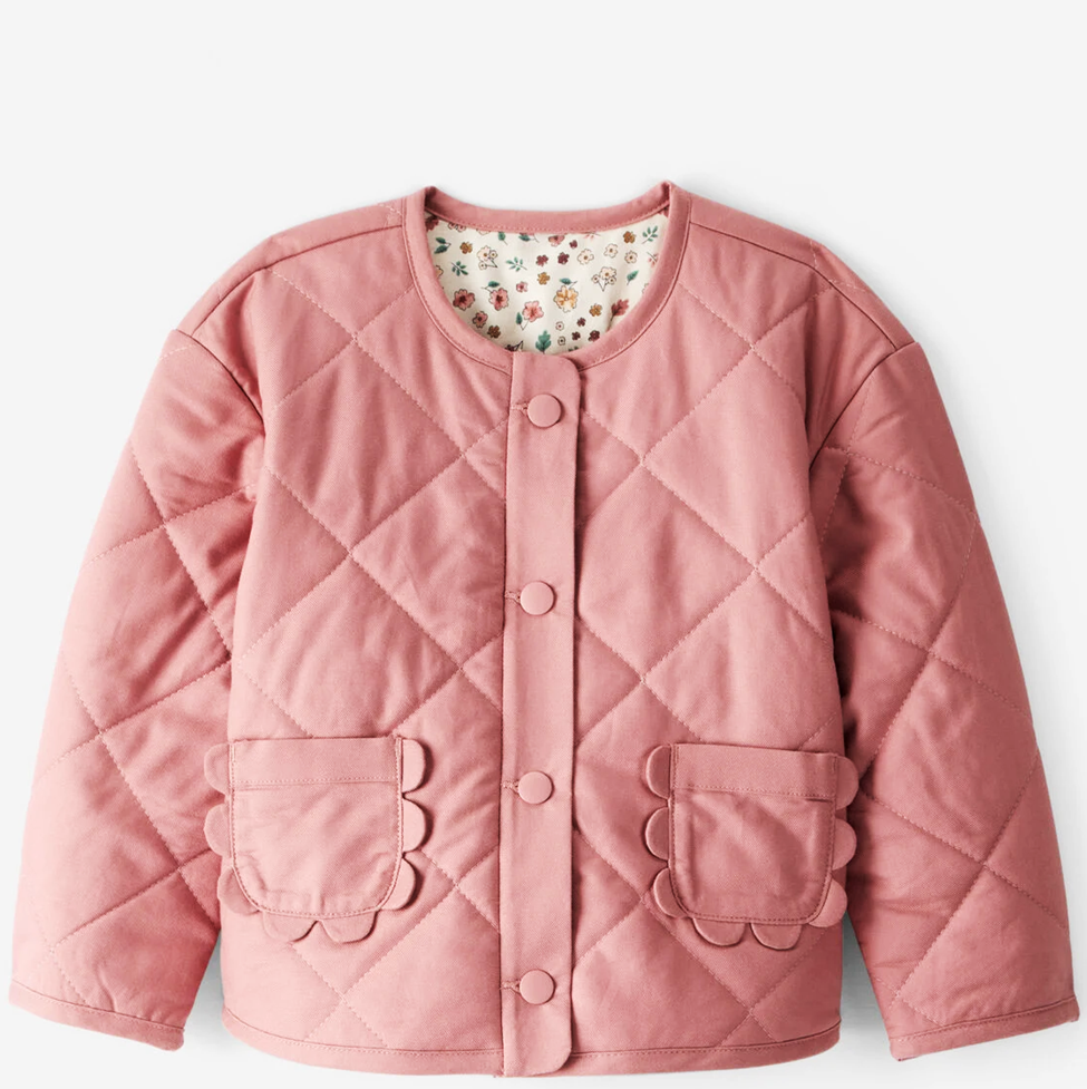 Pink quilted jacket with floral lining on a light gray background