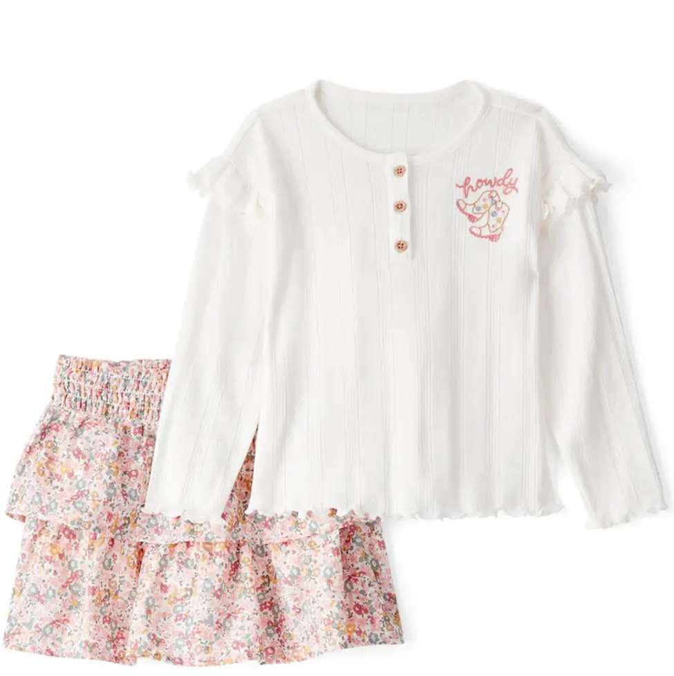 White long-sleeve top with floral skirt on a white background
