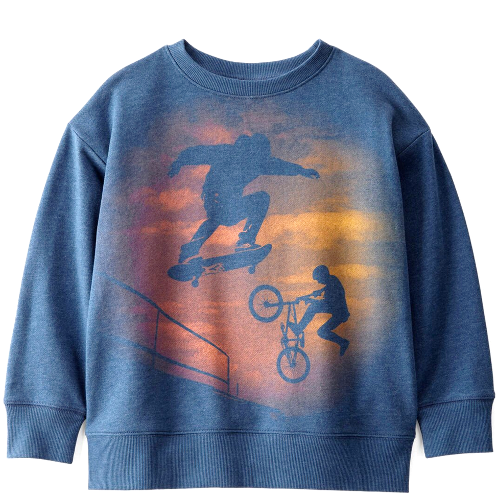 Blue sweatshirt with graphic of a skateboarder and biker against a sunset background
