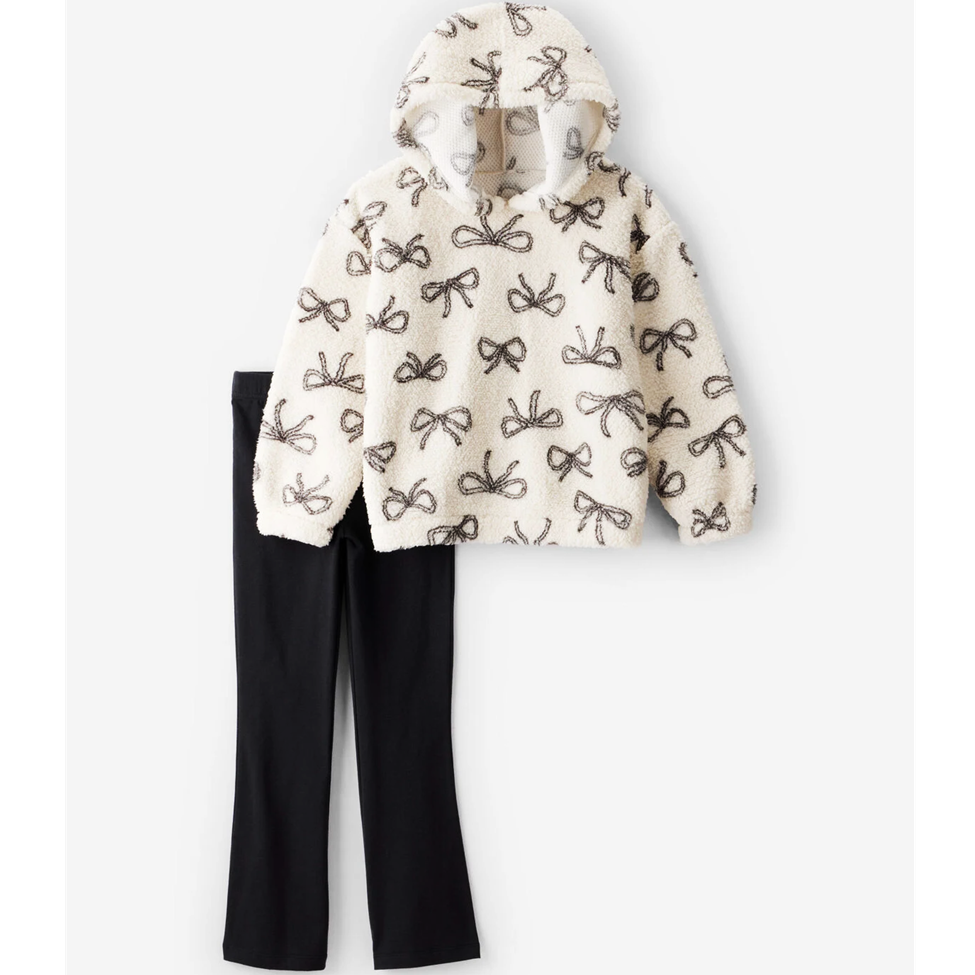 White hoodie with black bow pattern and black pants on a white background