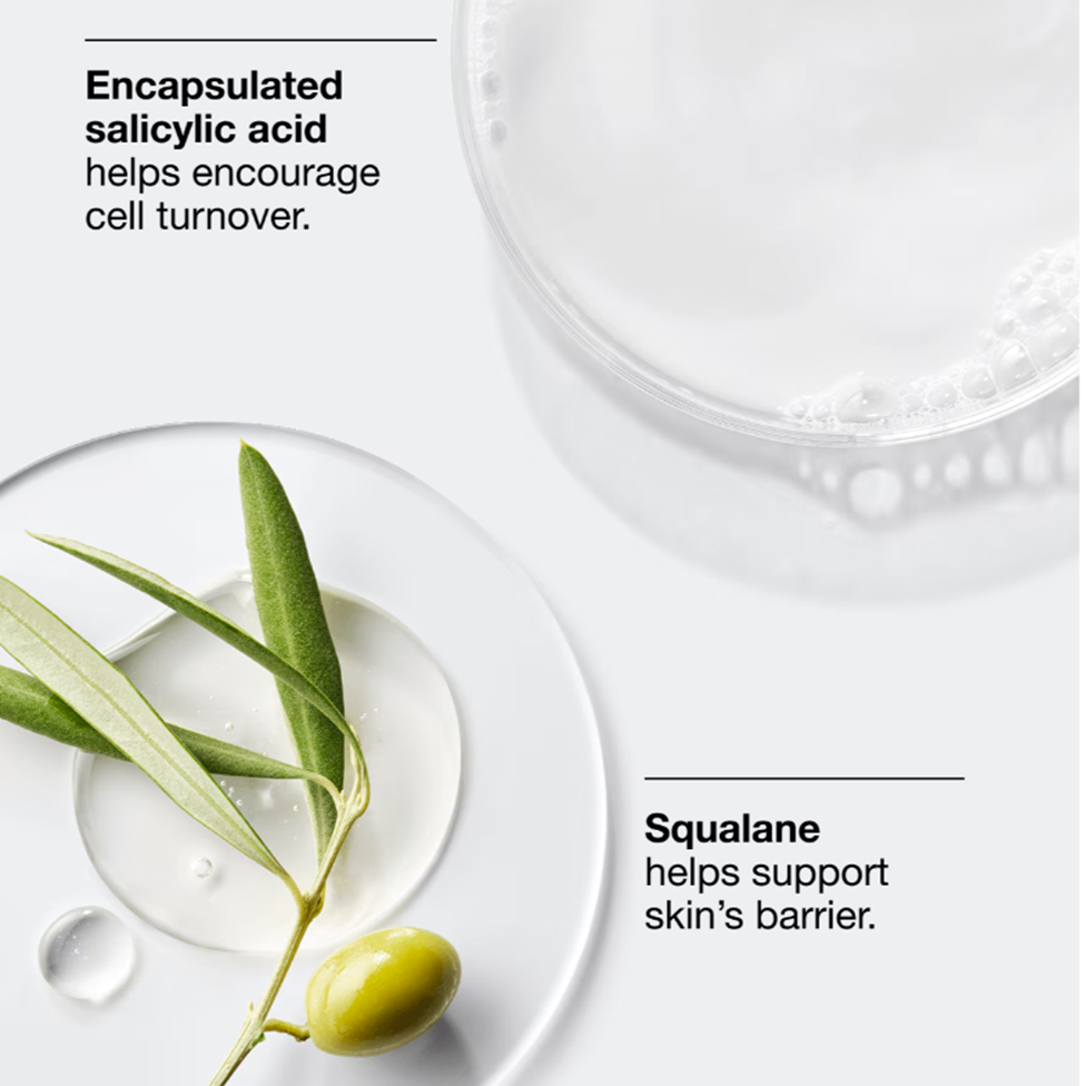 Cosmetic product with olive leaf and droplets on a white background, featuring text about salicylic acid and squalane.