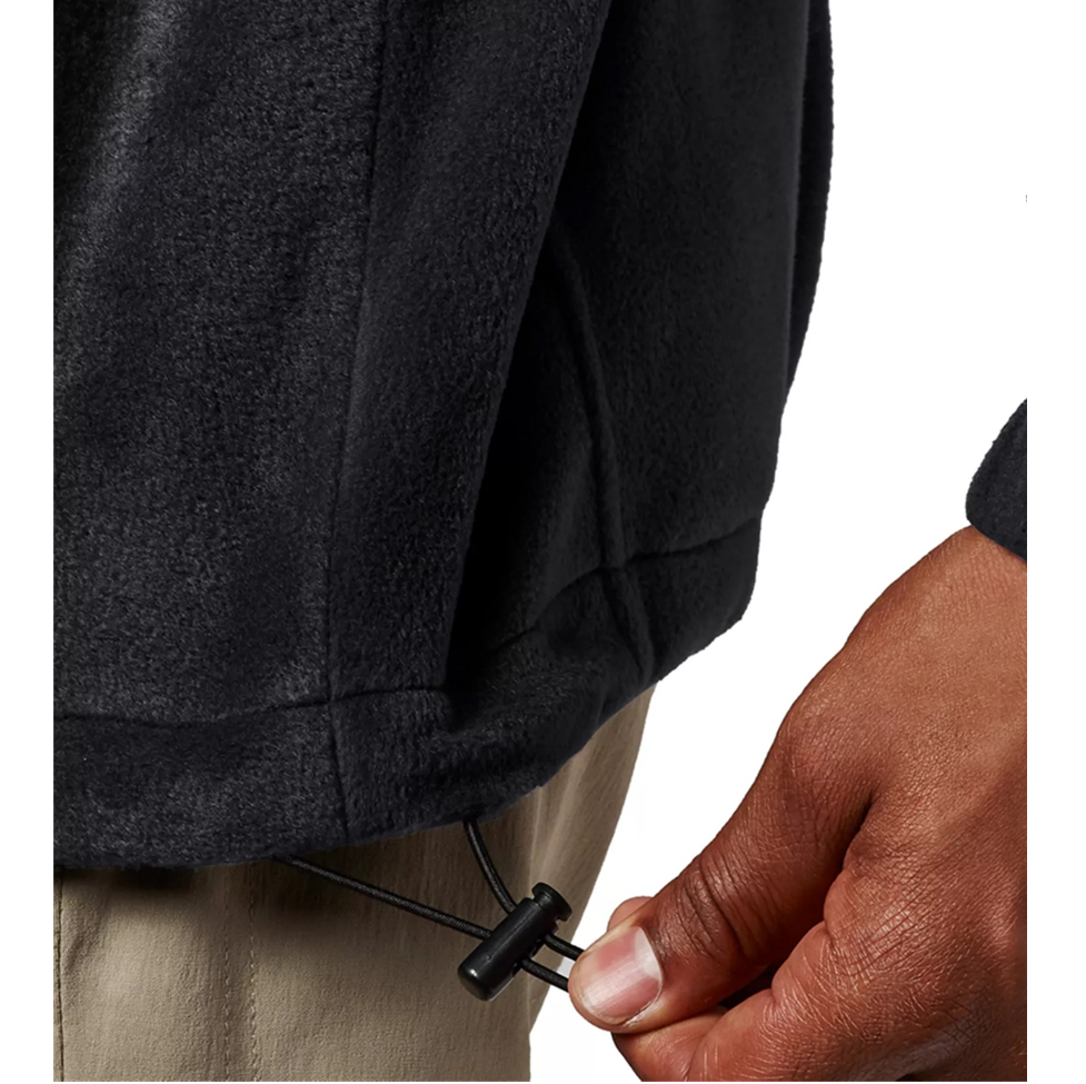 Person adjusting a black jacket zipper with a white background