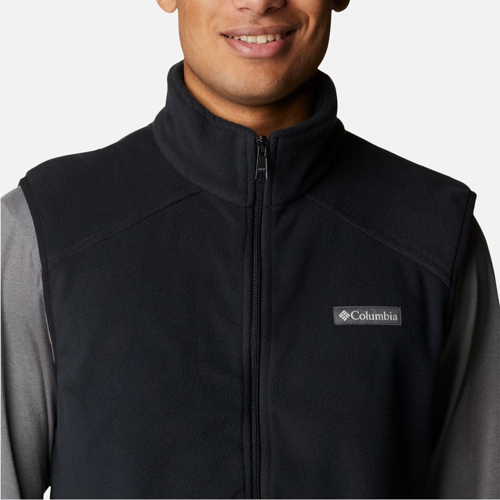 Black Columbia vest worn by a person on a white background