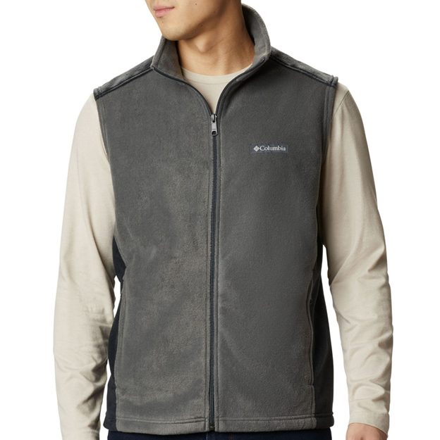 Person wearing a gray Columbia vest over a beige shirt on a white background