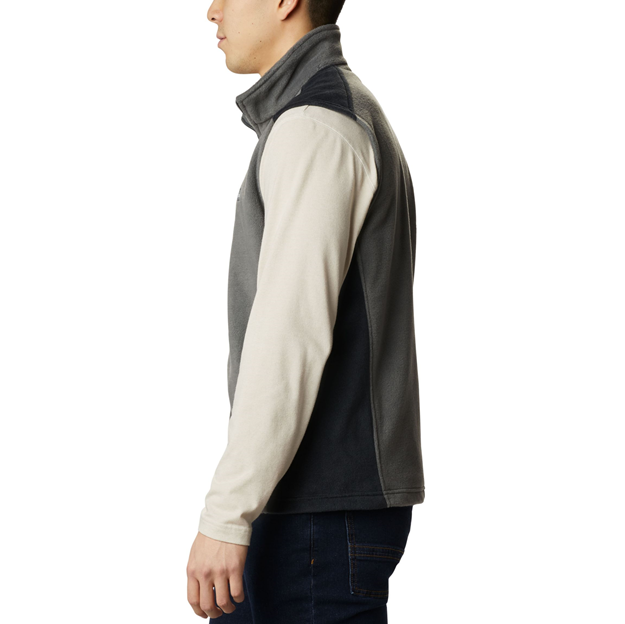 Person wearing a gray and beige fleece vest on a white background