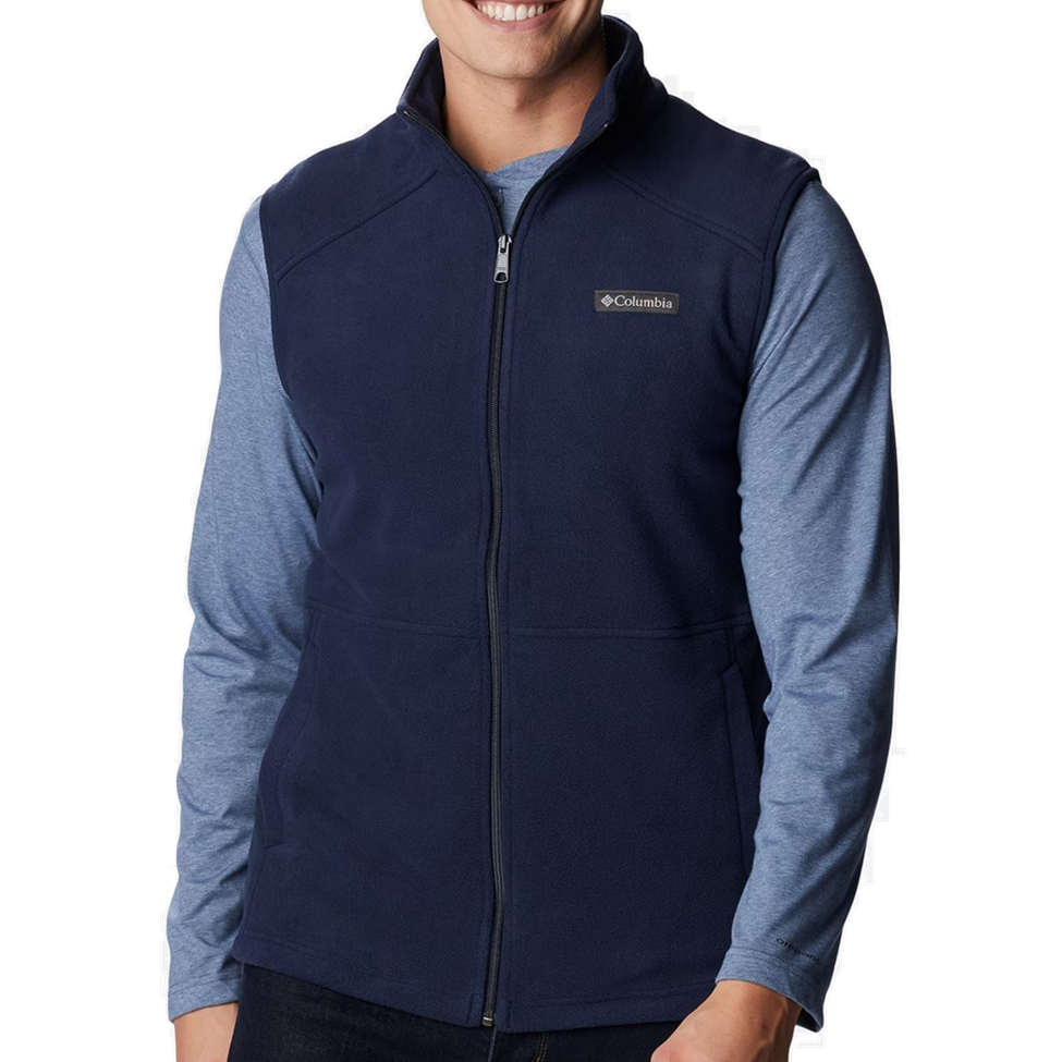 Person wearing a navy blue vest with Columbia logo on a white background