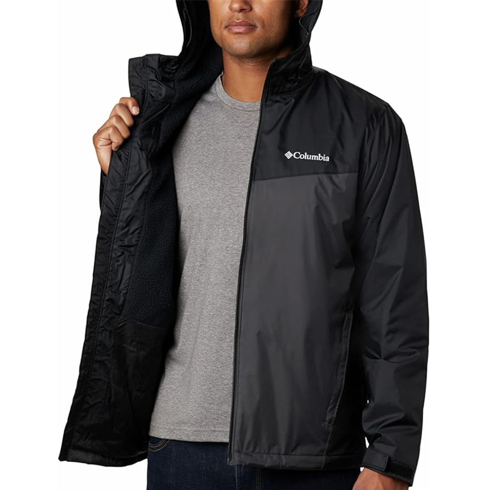 Person wearing a black Columbia jacket on a white background